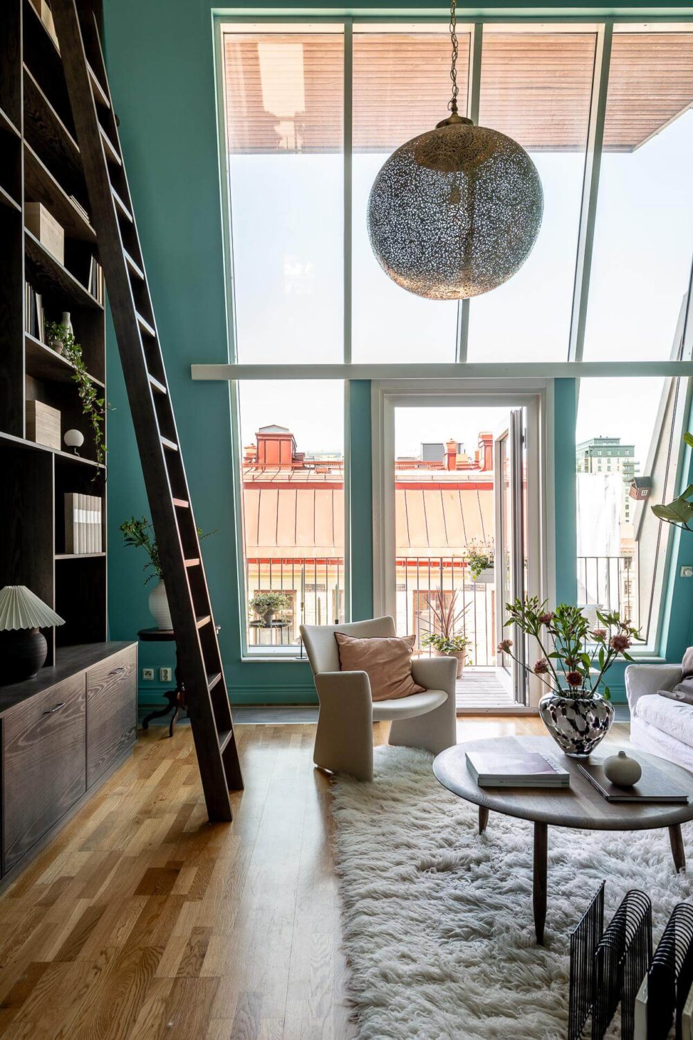 Floor-to-Ceiling Bookcases and Windows in a Loft Style Apartment 3 double height ceiling living room with huge windows and built in bookcases nordroom