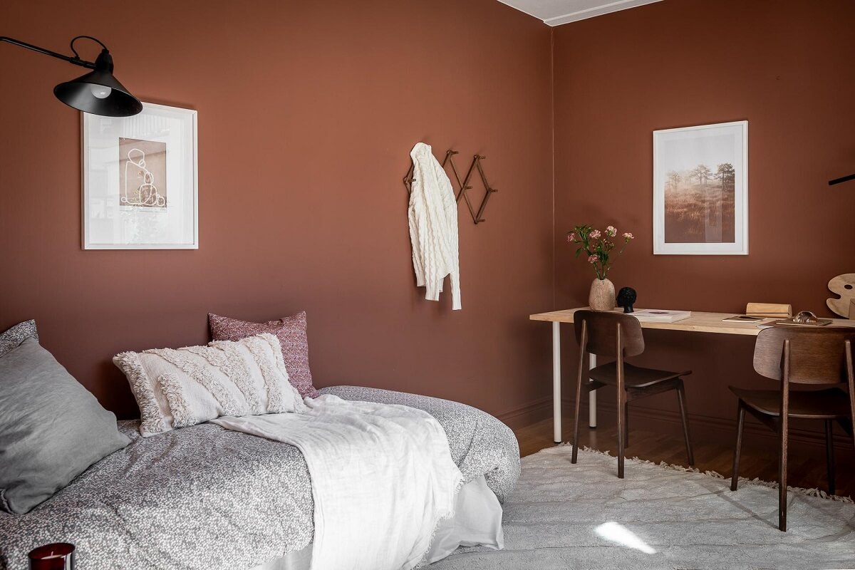 Floor-to-Ceiling Bookcases and Windows in a Loft Style Apartment 20 earthy brown bedroom with double desk