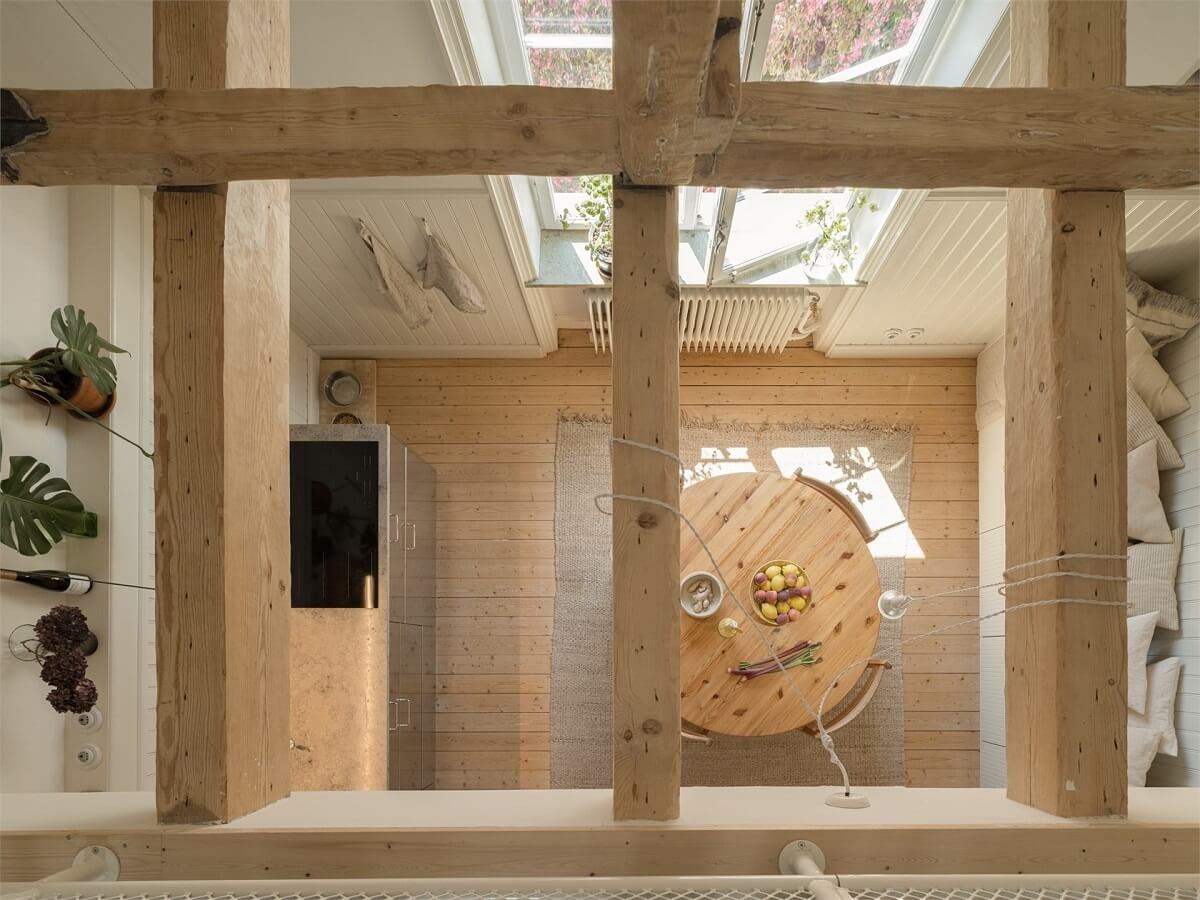 Wooden Details in a Light Duplex Apartment in Sweden 13 exposed beams kitchen view