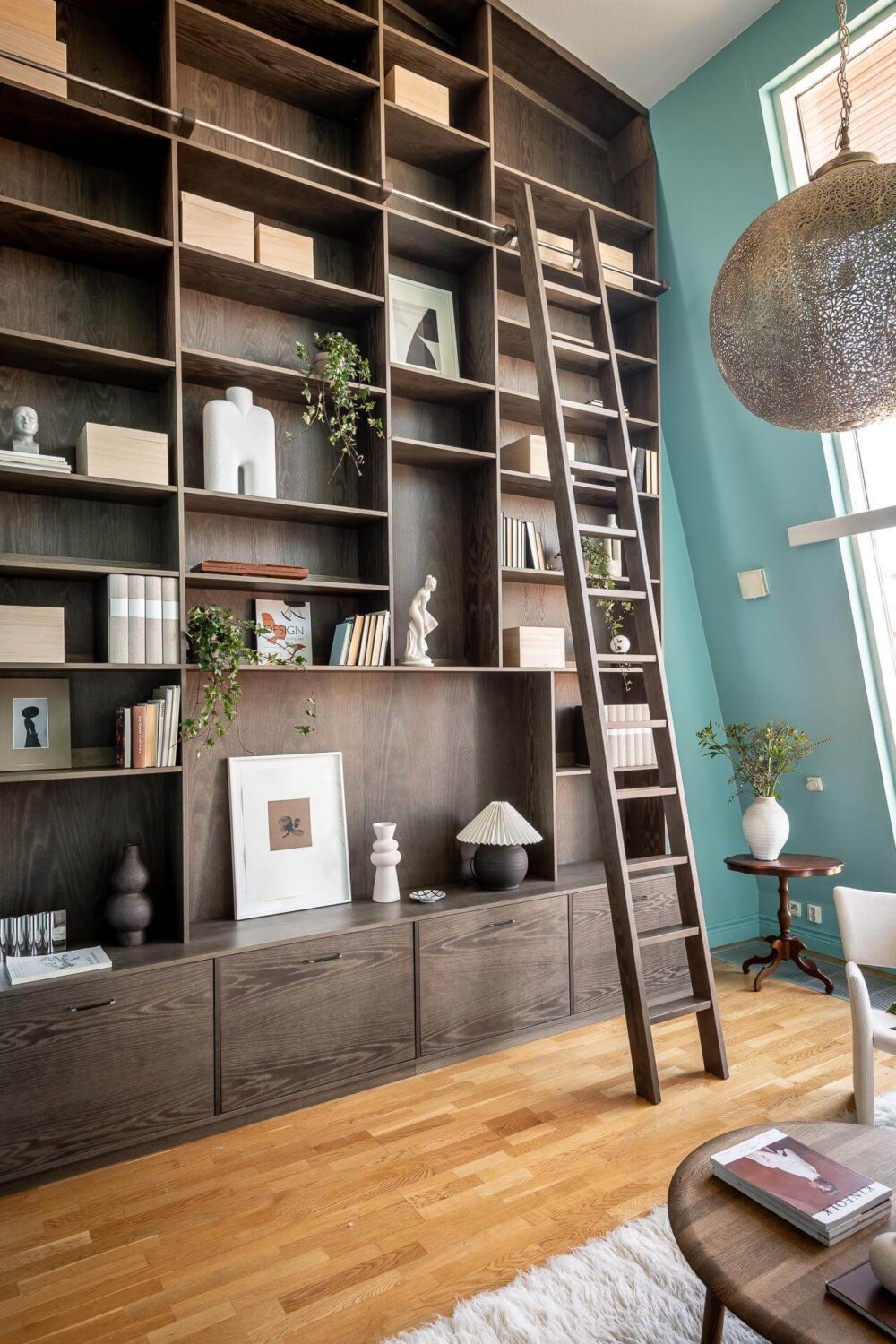 Floor-to-Ceiling Bookcases and Windows in a Loft Style Apartment 5 floor to ceiling bookcases in light blue living room nordroom