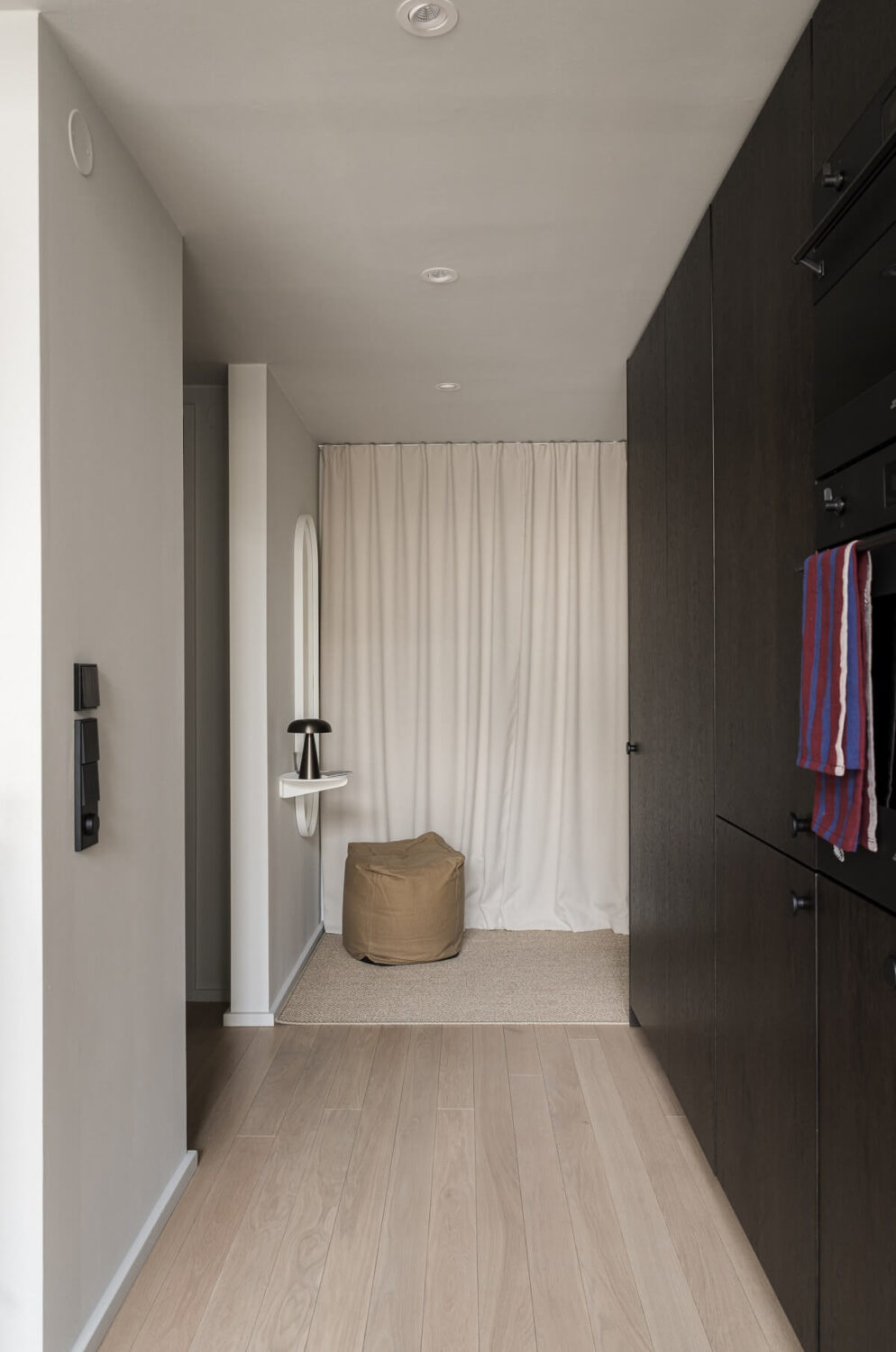 A Monochrome Loft with High Ceilings and Art 41 floor to ceiling cabinets in hallway
