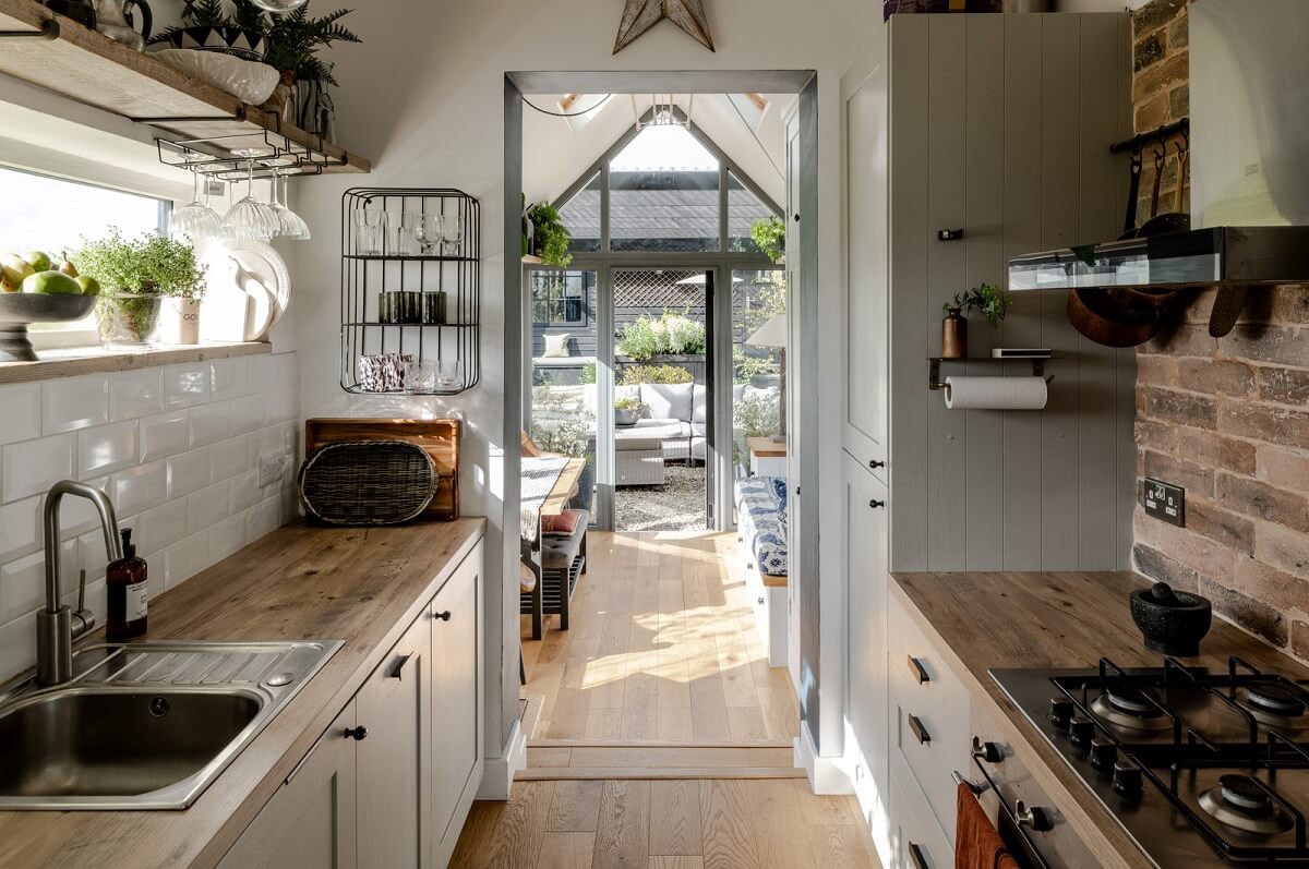 A Tiny Off-Grid House in the English Countryside 5 galley-kitchen-brick-wall