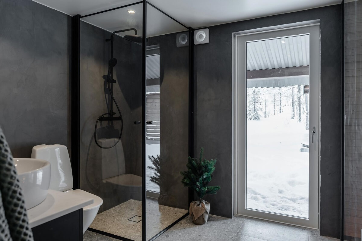 A Gray Swedish Log House Decorated for Christmas 17 gray bathroom with black fittings