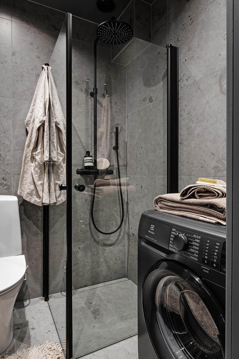 A Luxurious Renovated Apartment with Dark Gray Walls 26 gray bathroom with shower