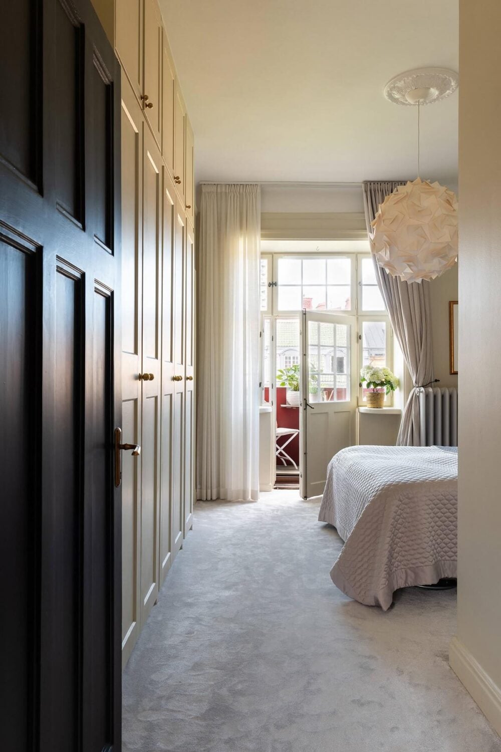 An Elegant Turn-of-the-Century Apartment in Stockholm 22 gray bedroom with floor to ceiling wardrobes and carpet nordroom