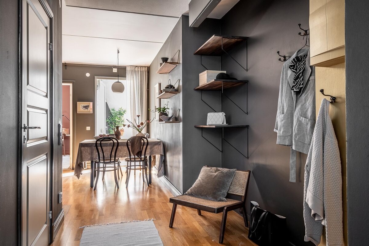 Floor-to-Ceiling Bookcases and Windows in a Loft Style Apartment 16 gray hallway with shelves