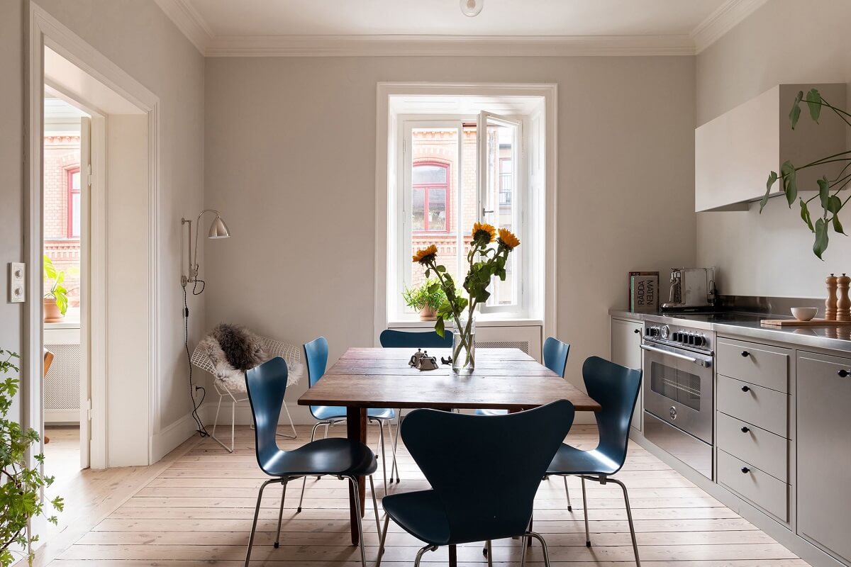 Light Rooms in a Renovated Historic Apartment in Stockholm 9 gray kitchen with large dining table nordroom