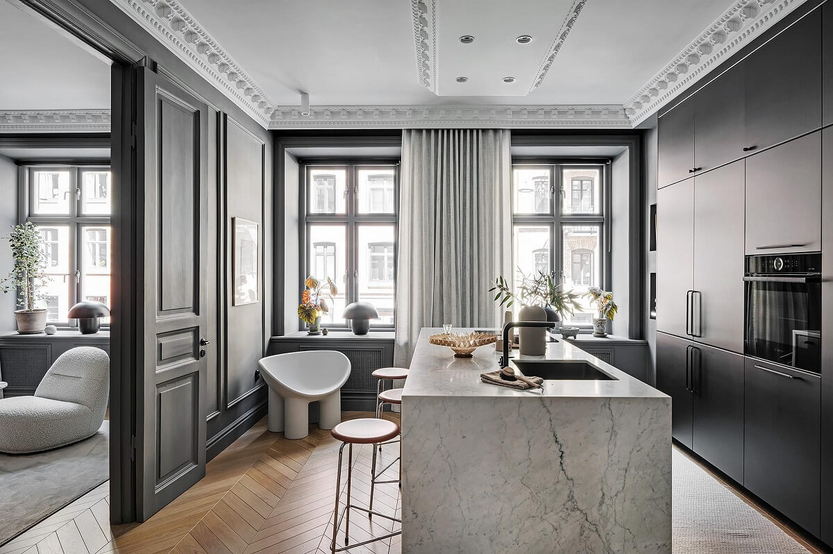 A Luxurious Renovated Apartment with Dark Gray Walls 15 gray kitchen with marble island