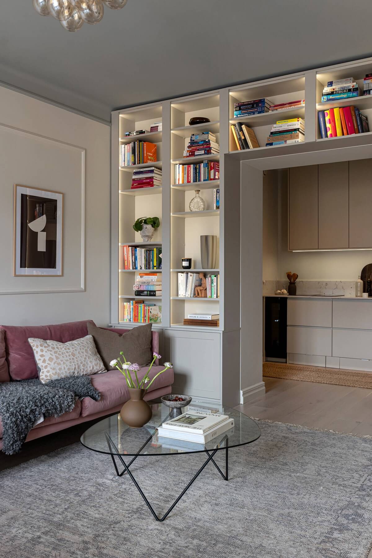 gray living room with lighted built in bookshelves