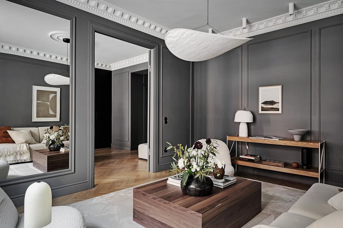 A Luxurious Renovated Apartment with Dark Gray Walls 8 gray living room with wooden square coffee table