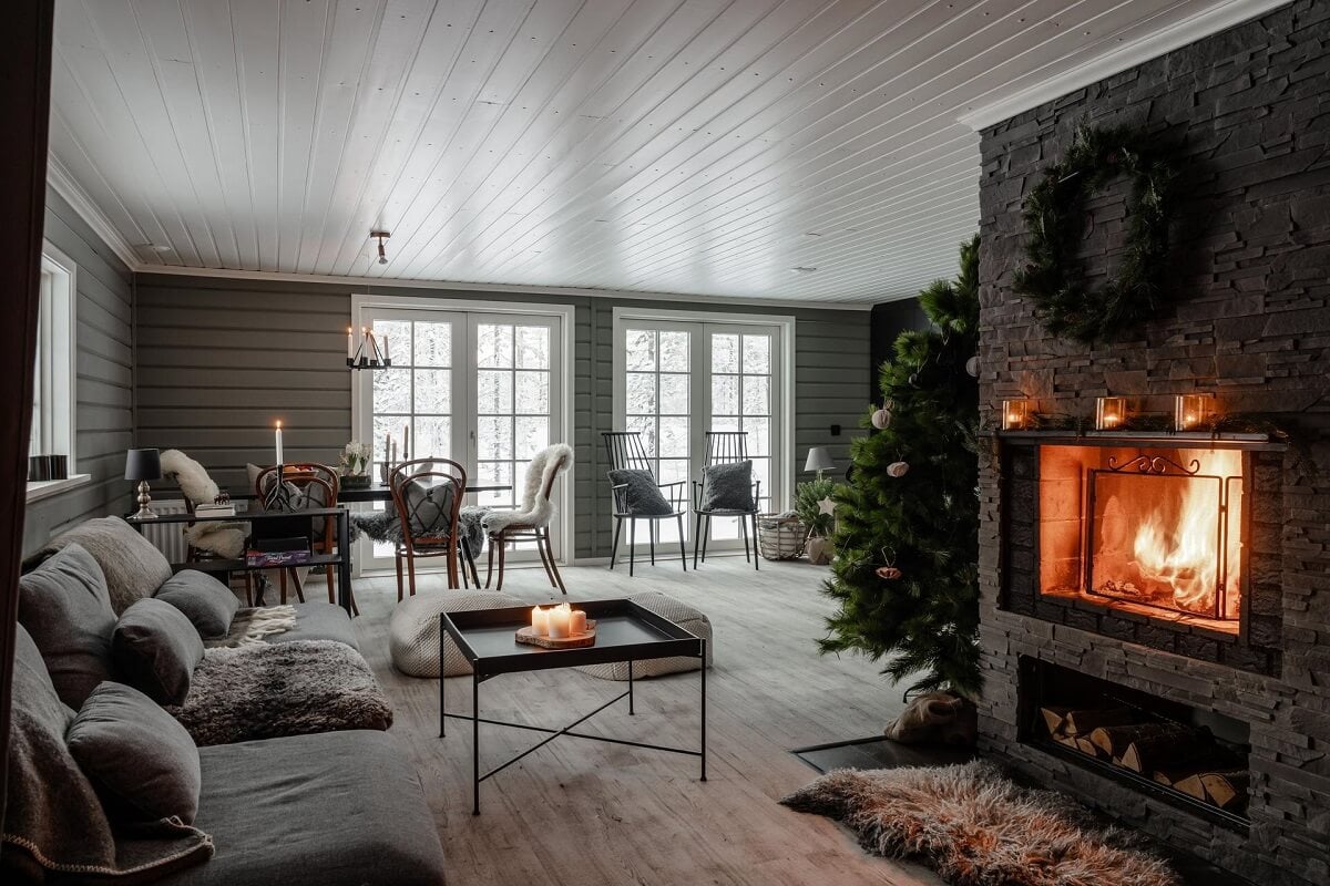 gray log house living room with fireplace and christmas decor nordroom