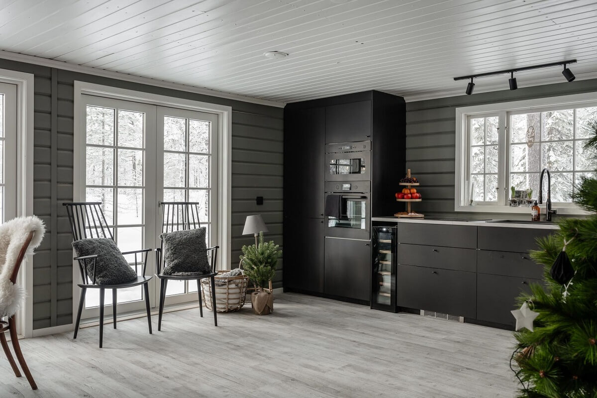 A Gray Swedish Log House Decorated for Christmas 7 gray log house with black kitchen