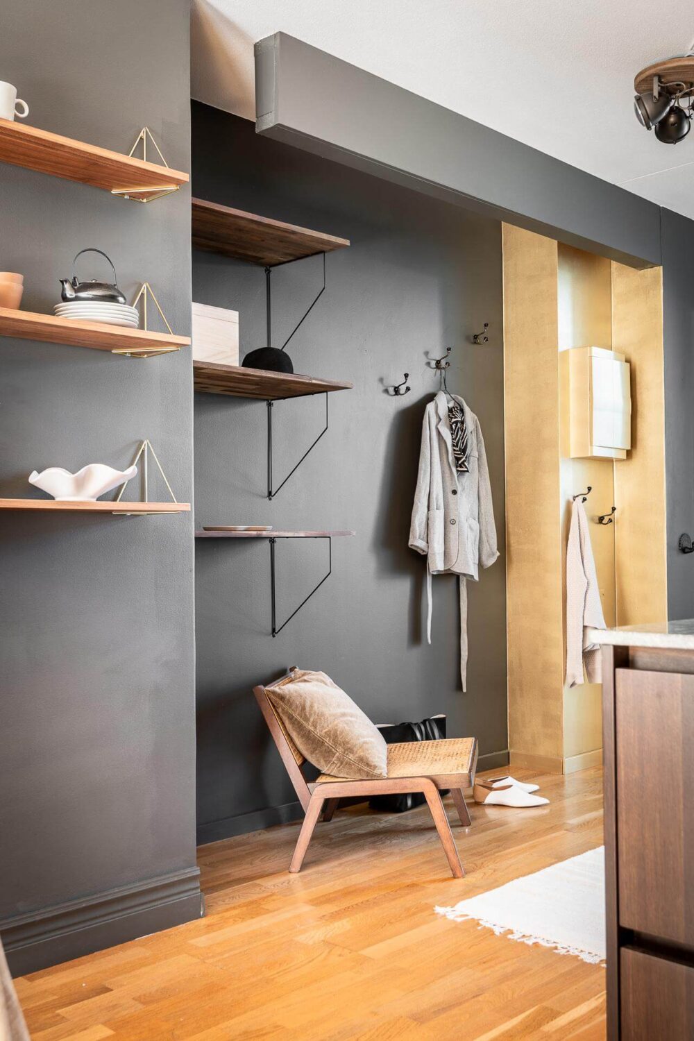 Floor-to-Ceiling Bookcases and Windows in a Loft Style Apartment 15 gray walls and shelves in hallway nordroom