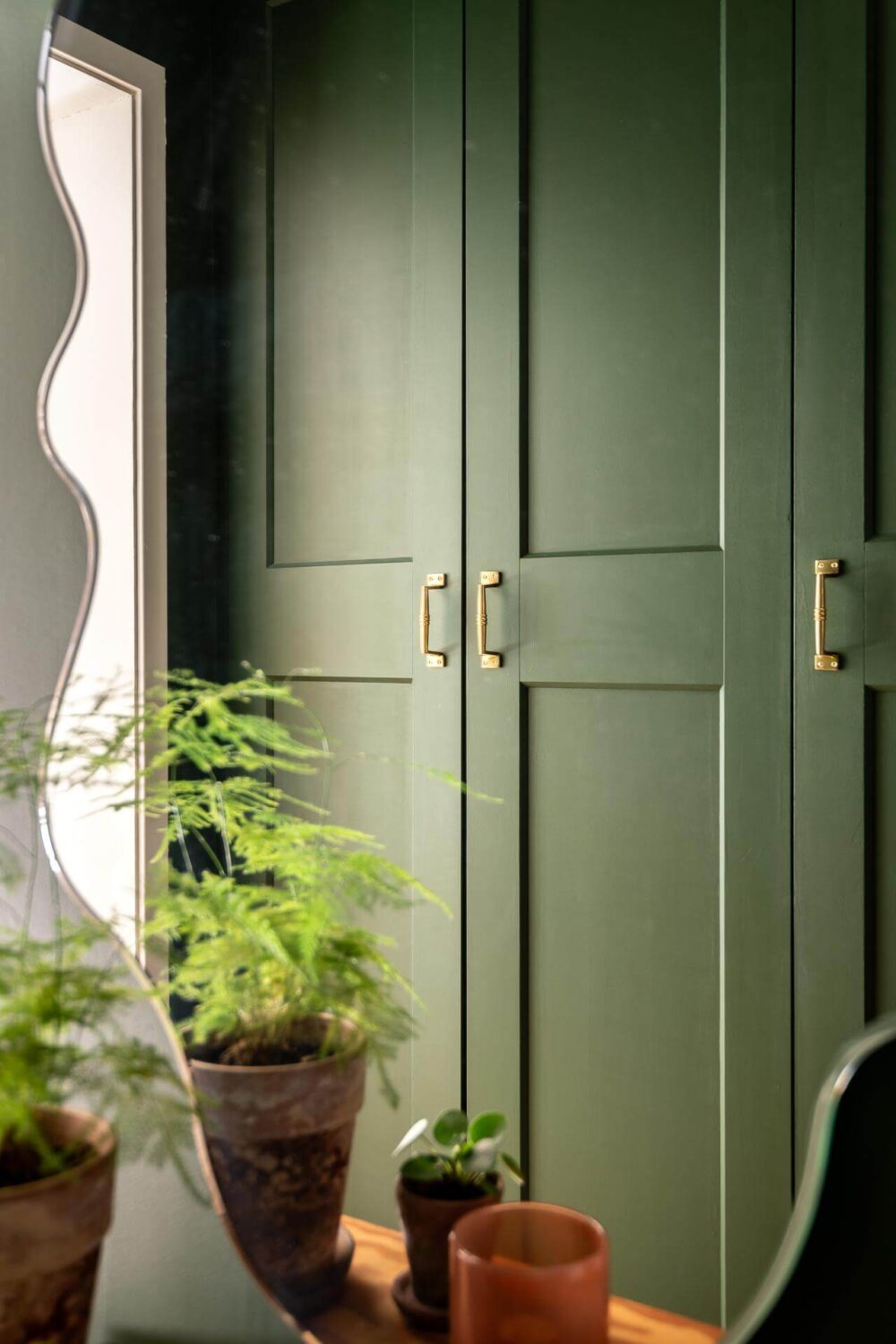 A Turn of the Century Apartment with a Green Kitchen 22 green cabinets hallway