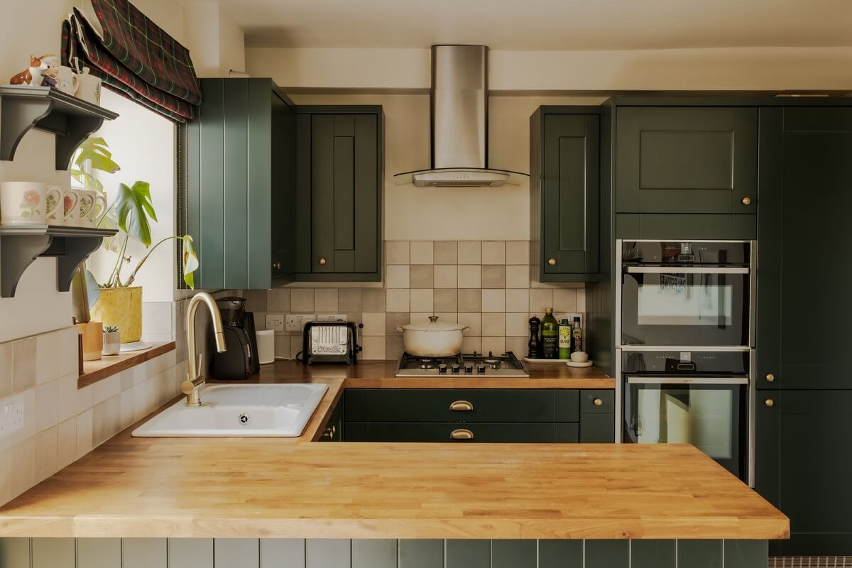 A Rich Color Palette in a Historic English Home 5 green kitchen with wooden worktop