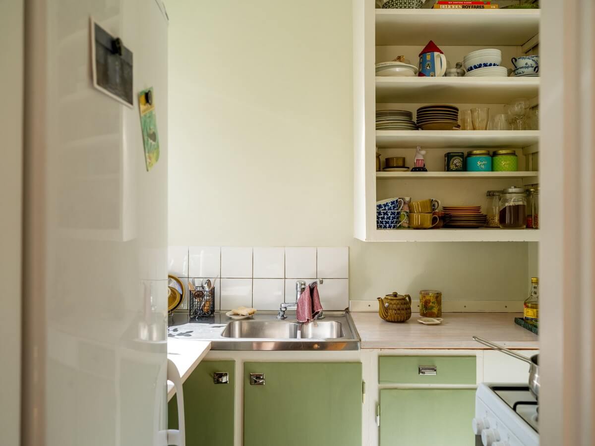 A Studio Apartment with Vintage Green Cabinets 11 green vintage kitchen