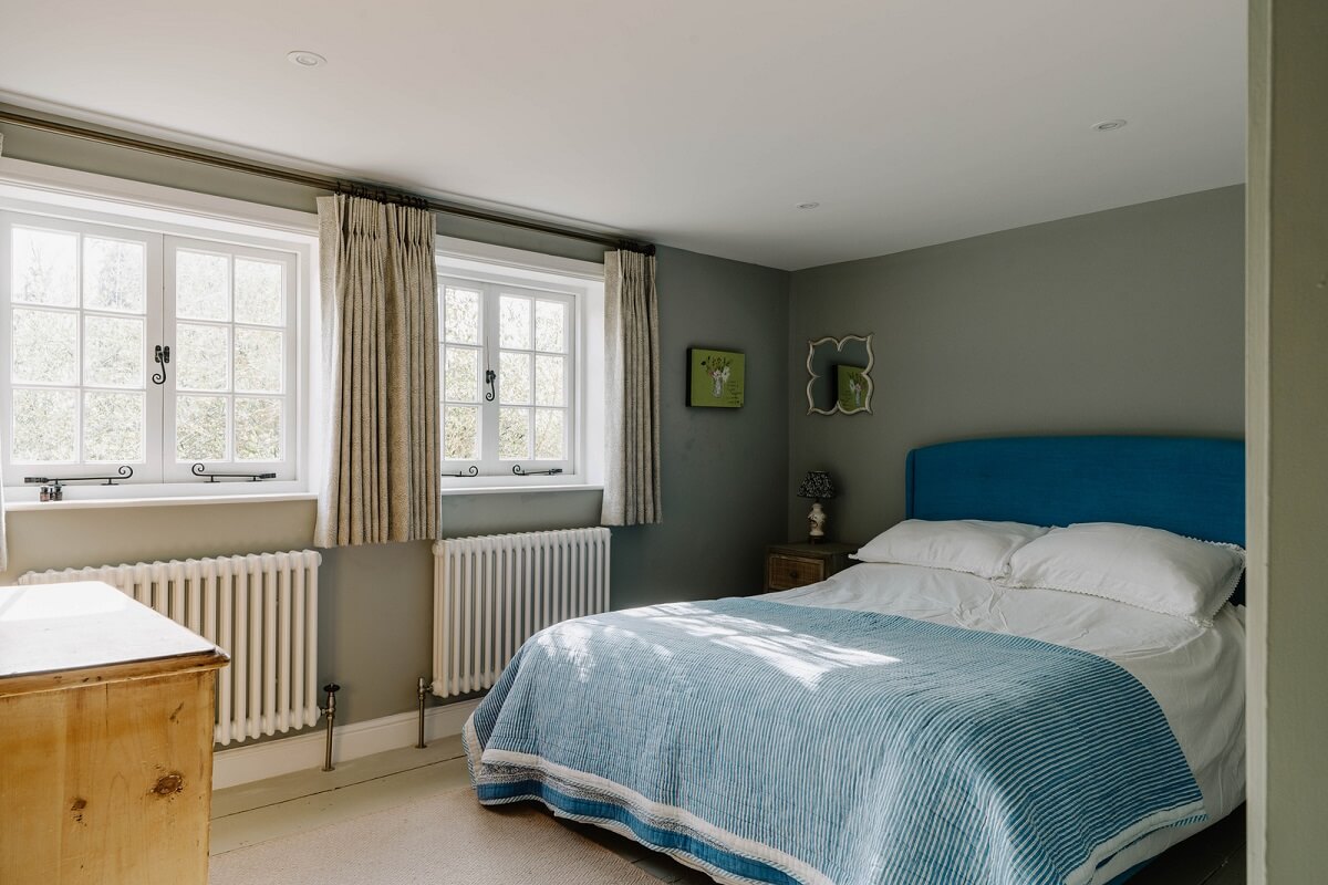 An 18th-Century Historic House with an Amazing Kitchen 26 guest house bedroom with blue headboard