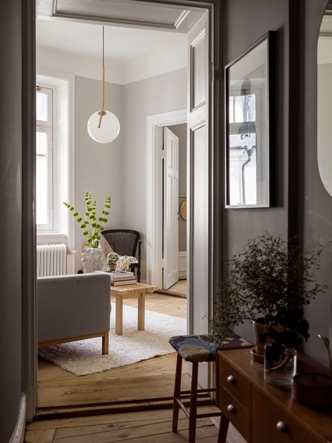 A Gray Stockholm Apartment with a Black Kitchen 1 hallway view into living room
