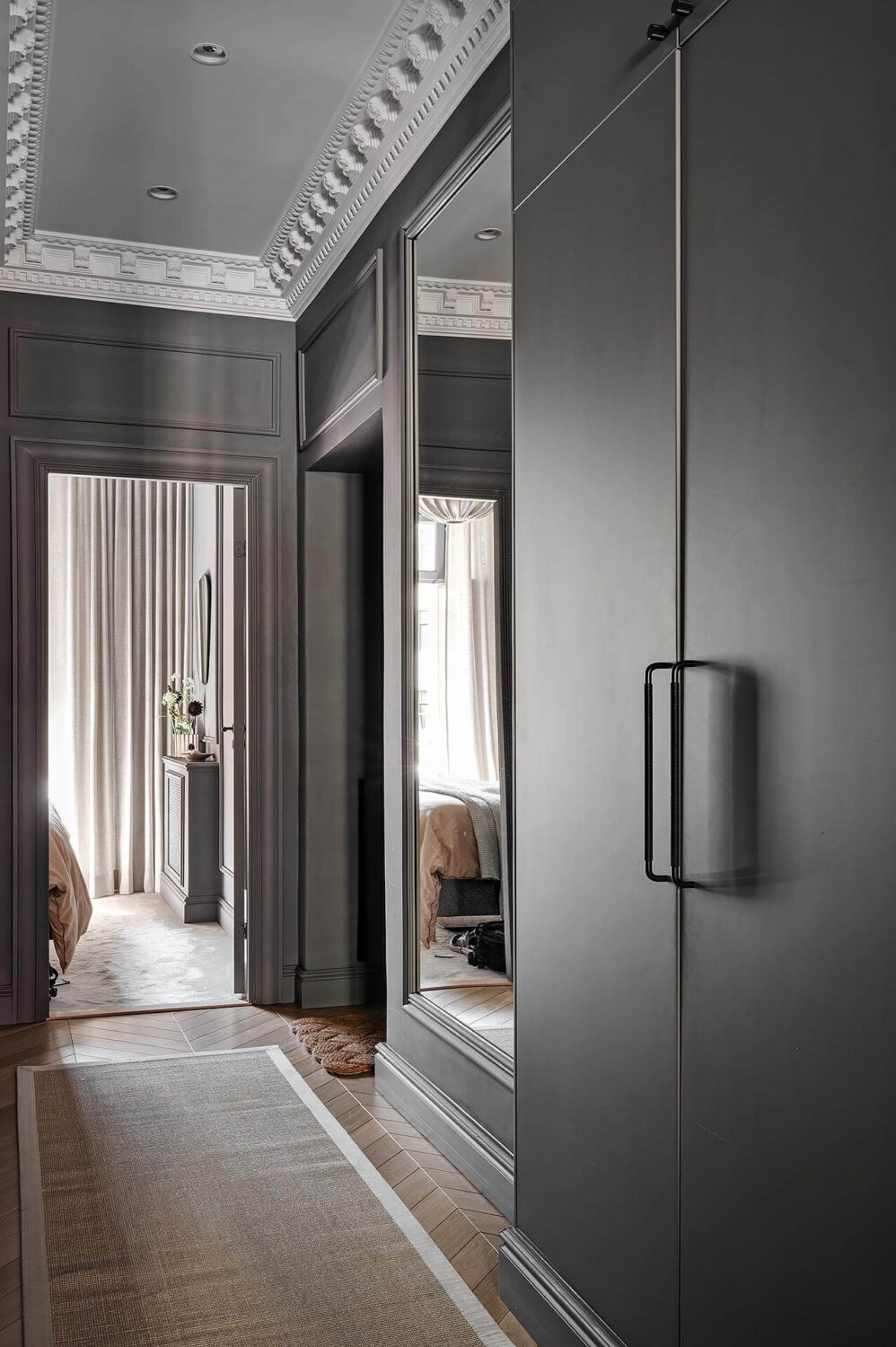 A Luxurious Renovated Apartment with Dark Gray Walls 17 hallway with built in cabinets