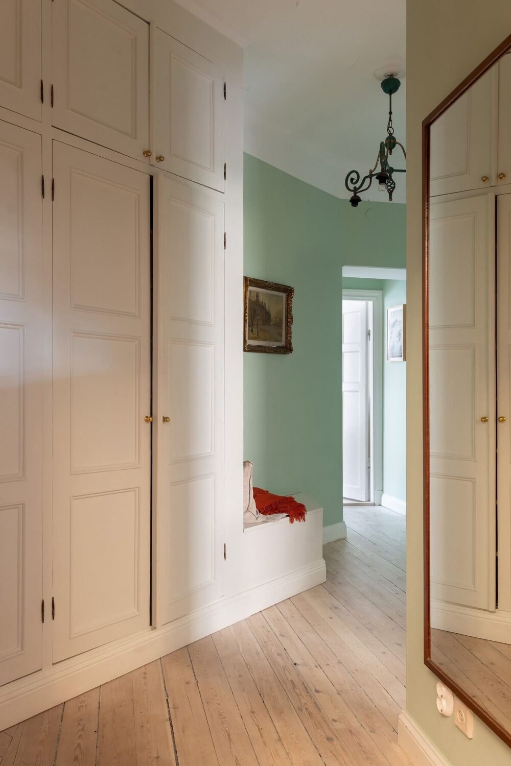 A Swedish Apartment with a Yellow Kitchen 19 hallway with built in cabinets and bench