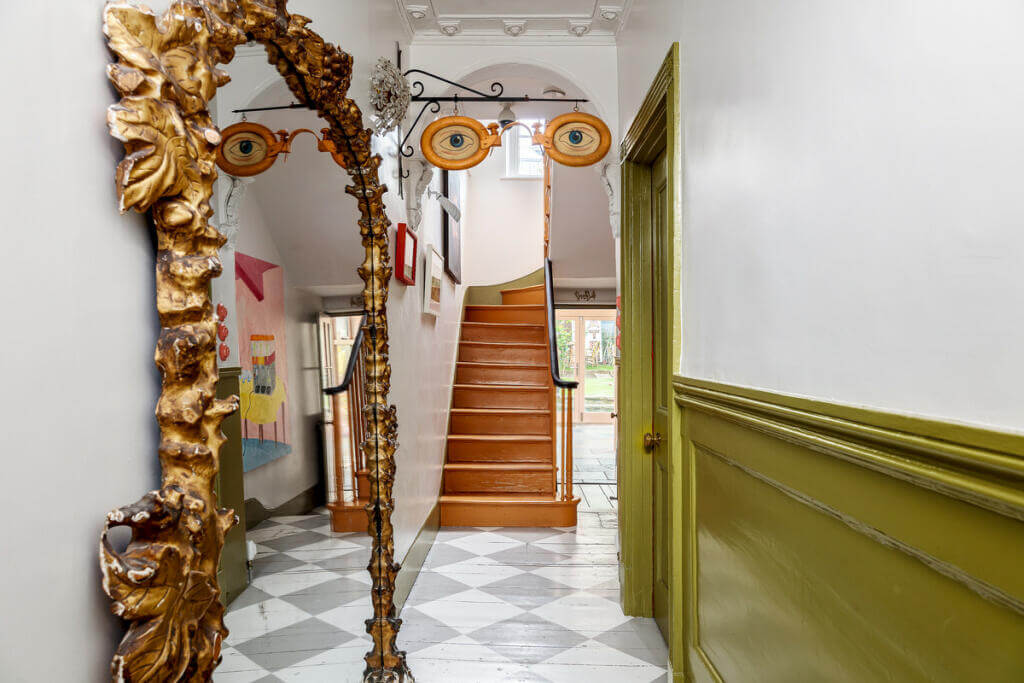Unique Color Combinations and Design in a London Townhouse 8 hallway with checkerboard floor and green paneling