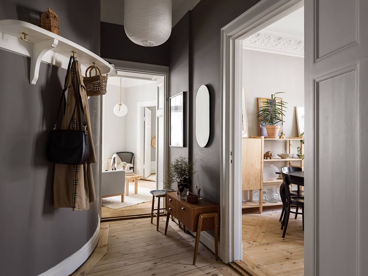 A Gray Stockholm Apartment with a Black Kitchen 18 hallway with curved wall and gray paint