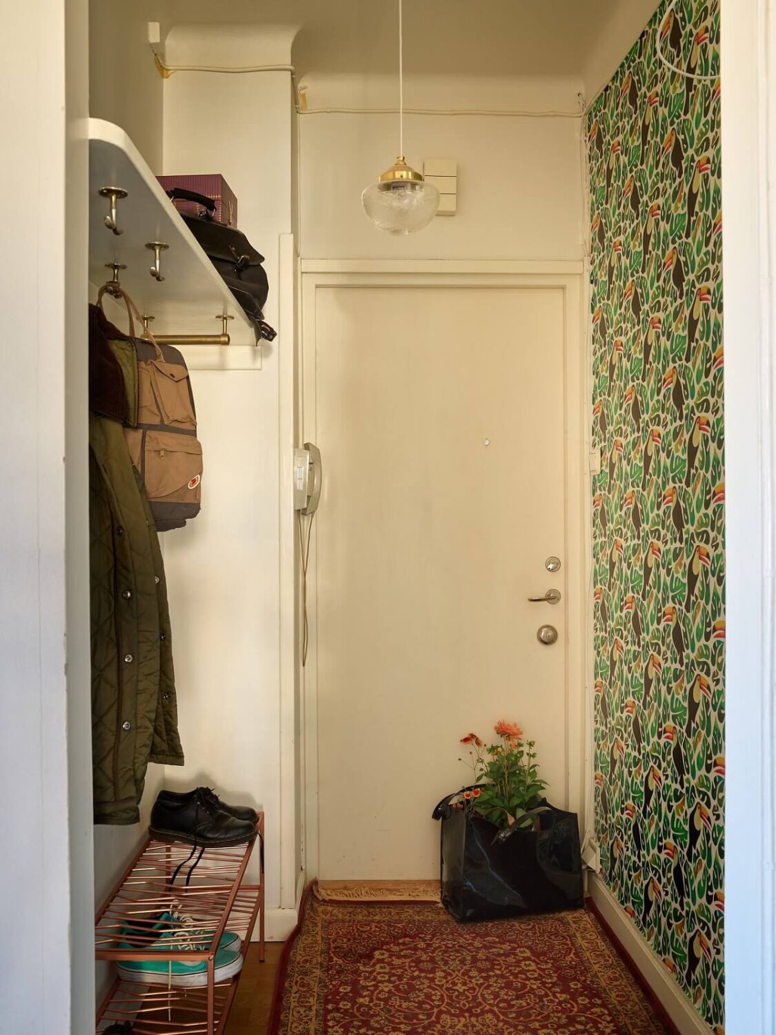 A Vintage Apartment with a Vibrant Blue Bedroom 17 hallway with green wallpaper