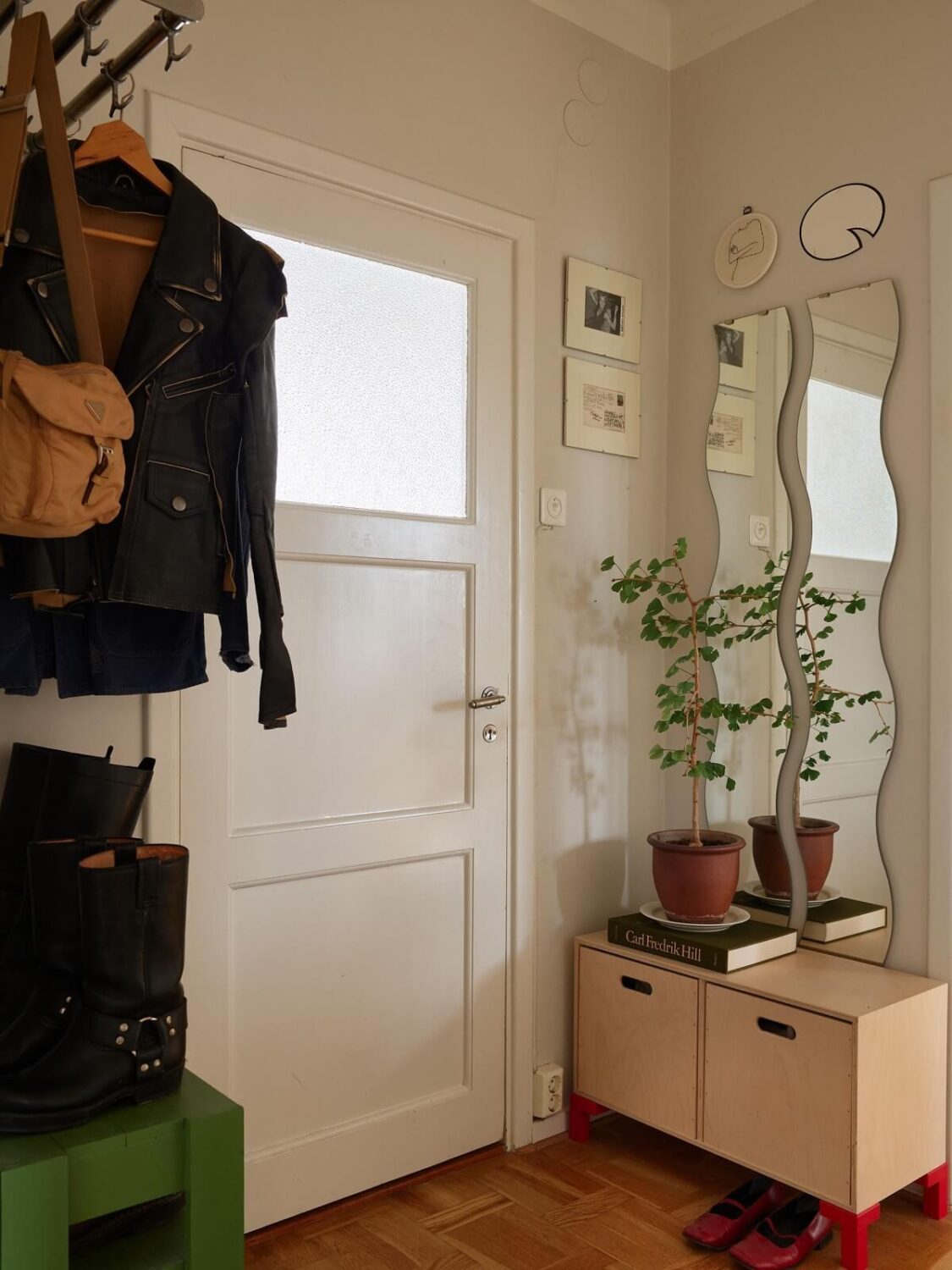 A Swedish Apartment with a Restored Original Kitchen 20 hallway with low cabinets and wavy mirrors