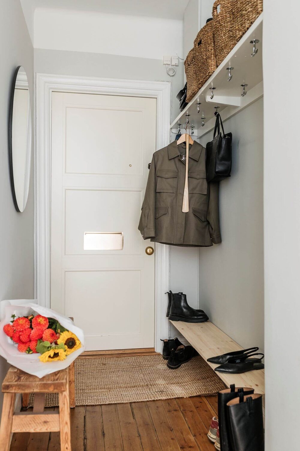 A Small Renovated 1920s Apartment in Stockholm 16 hallway with shelves A Small Renovated 1920s Apartment in Stockholm