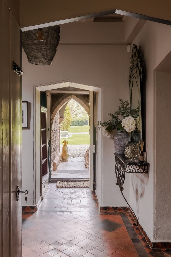 A Charming Gothic-Style Home with Original Details 10 hallway with stone floornordroom
