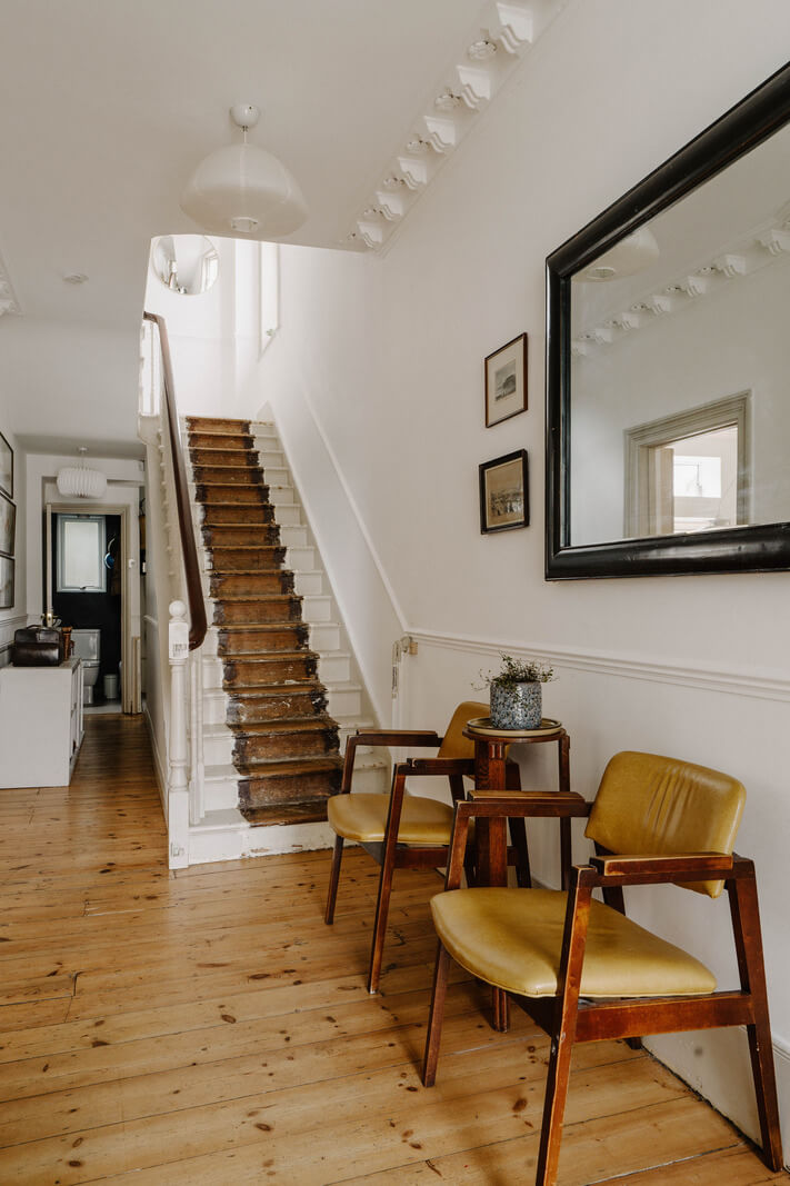Neutral Tones and Original Features in an English Townhouse 15 hallway with stripped staircase