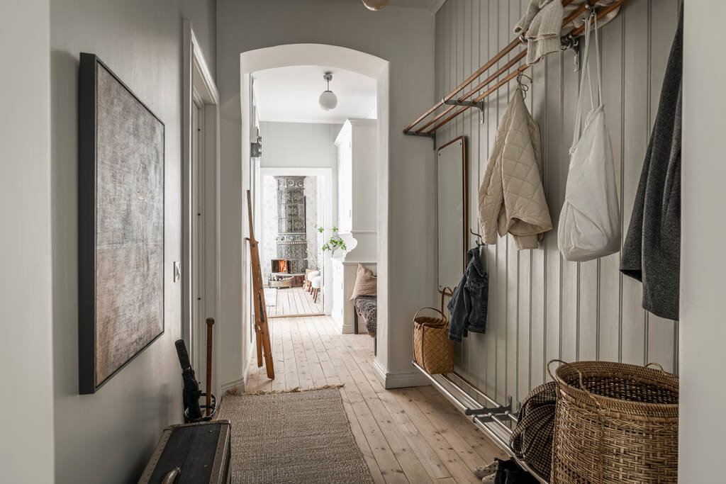 Wallpaper and Historic Charm in a Swedish Apartment 33 hallway with wood paneled walls
