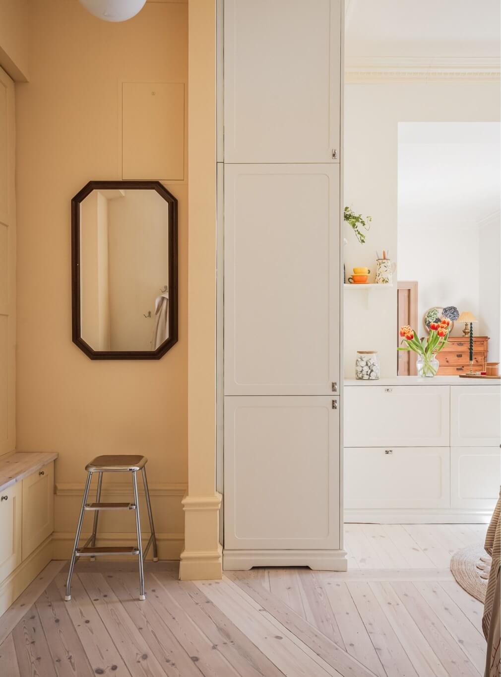 Warm Color Tones in a Scandinavian Apartment 13 hallway with yellow wall