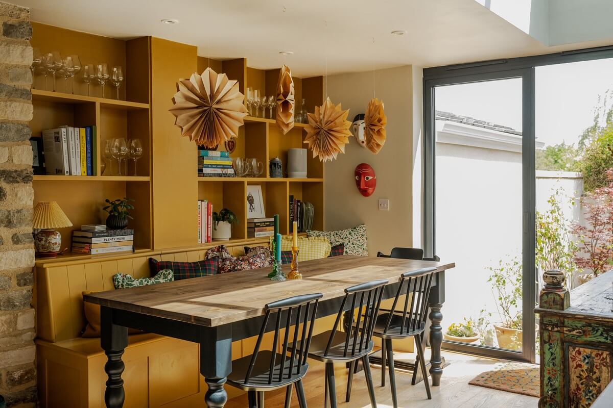 A Rich Color Palette in a Historic English Home 2 india yellow bench and cabinet dining room nordroom
