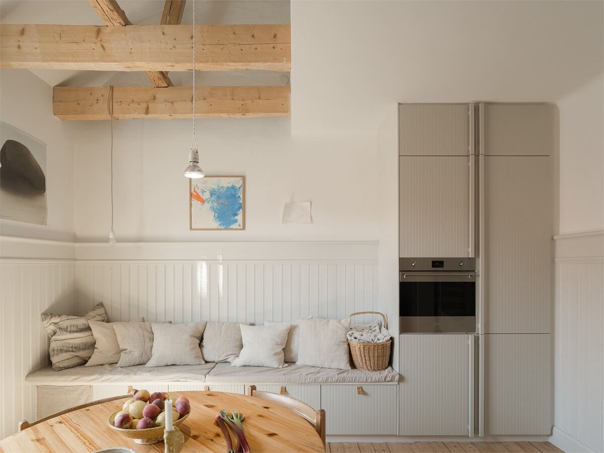Wooden Details in a Light Duplex Apartment in Sweden 9 kitchen built in seating with storage