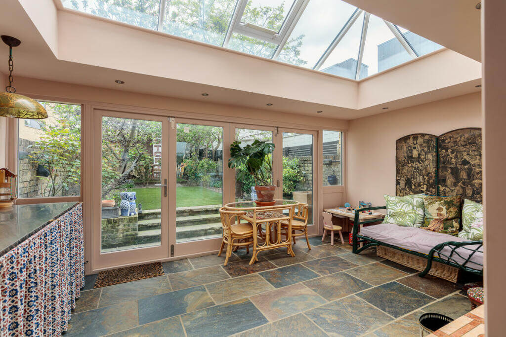 Unique Color Combinations and Design in a London Townhouse 13 kitchen space with flagstone floor and skylight