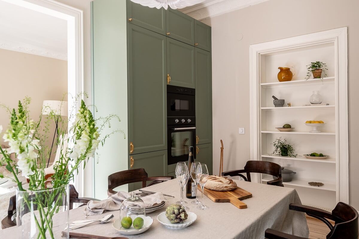 A Turn of the Century Apartment with a Green Kitchen 11 kitchen table and built in shelves