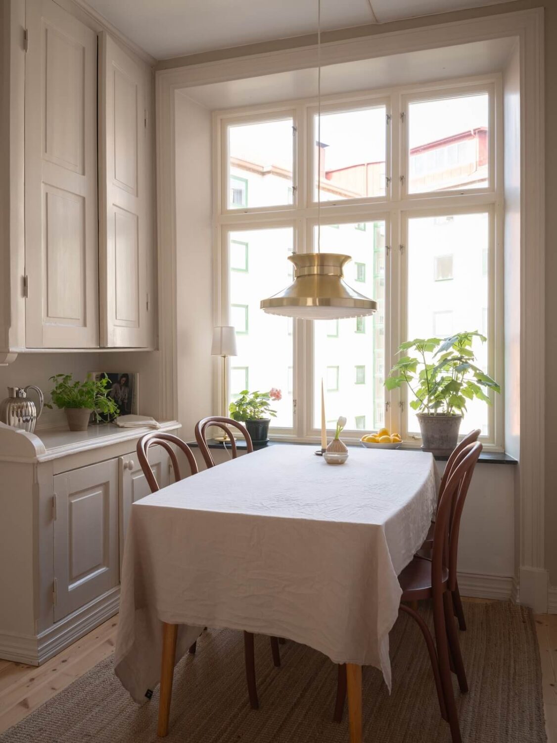 Light-Filled Rooms in a Historic Gothenburg Apartment 18 kitchen table with original built in cabinets