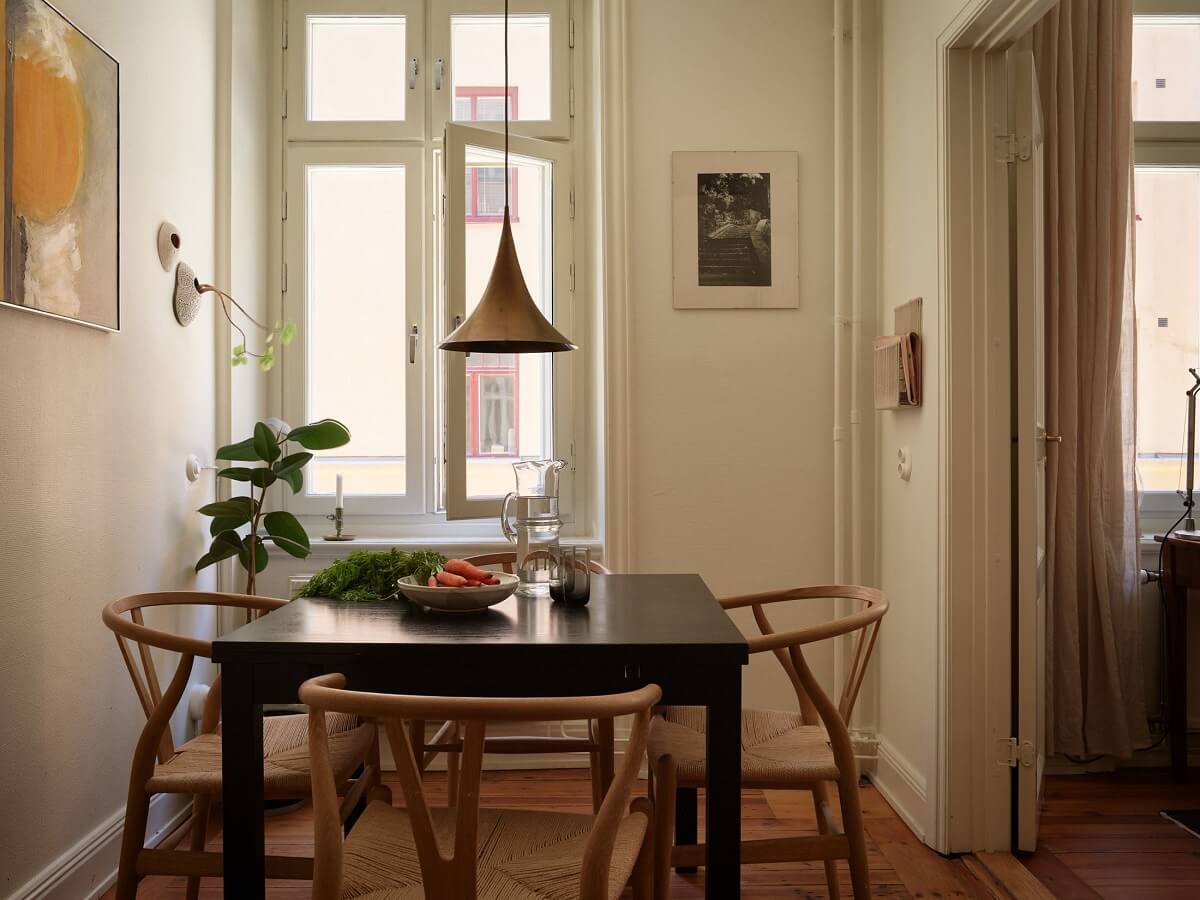 Warm Tones and a Blue Hallway in a Stockholm Apartment 12 kitchen table with wishbone chairs