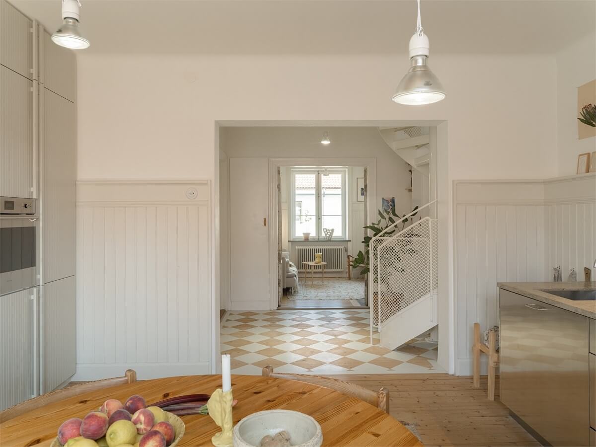 Wooden Details in a Light Duplex Apartment in Sweden 14 kitchen view into hall
