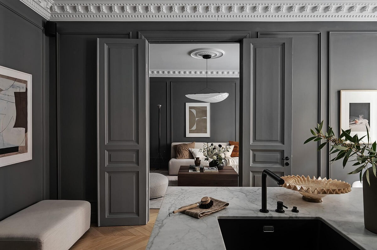 A Luxurious Renovated Apartment with Dark Gray Walls 14 kitchen view into living room