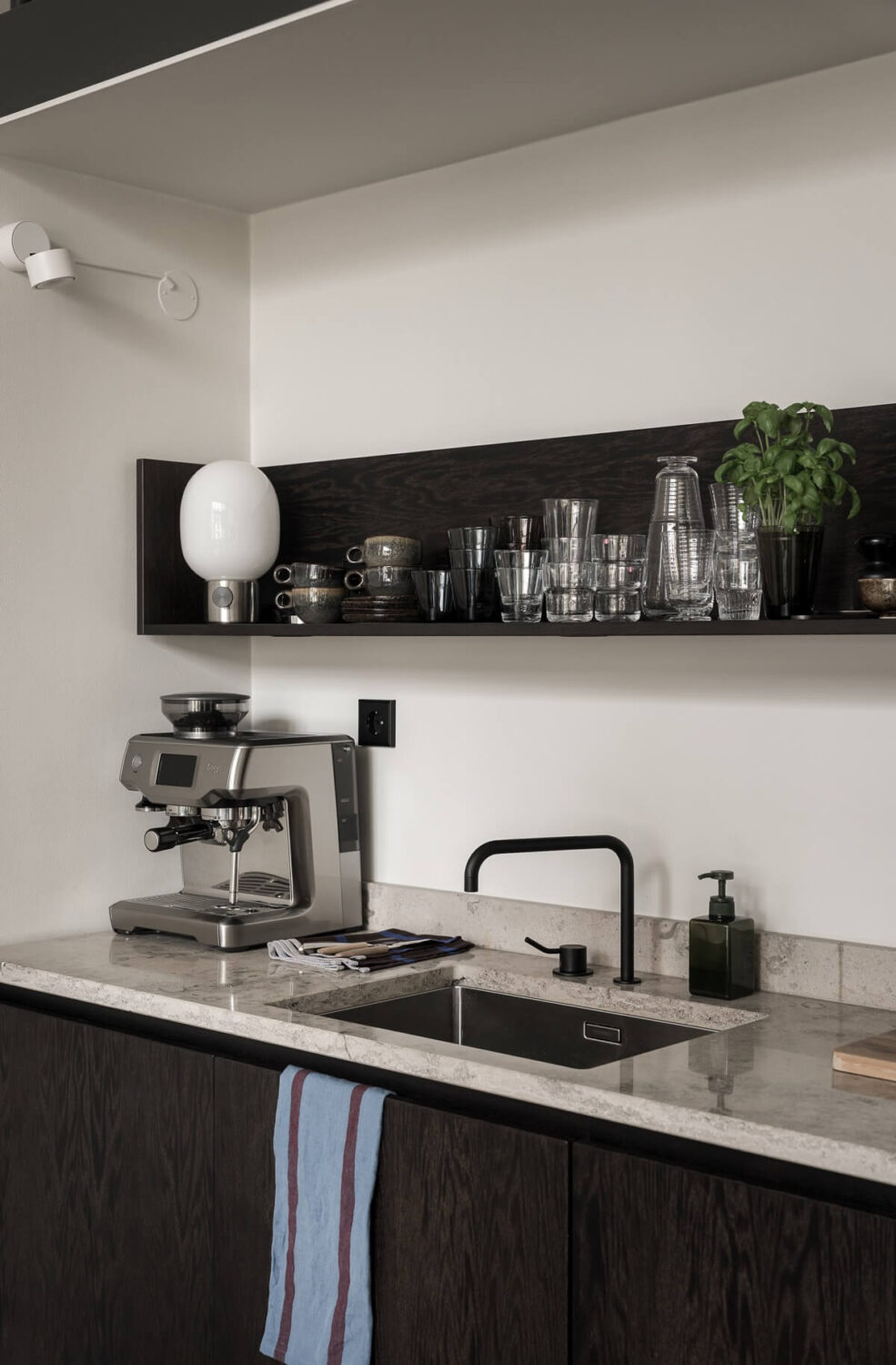 A Monochrome Loft with High Ceilings and Art 23 kitchen with black fittings and shelf