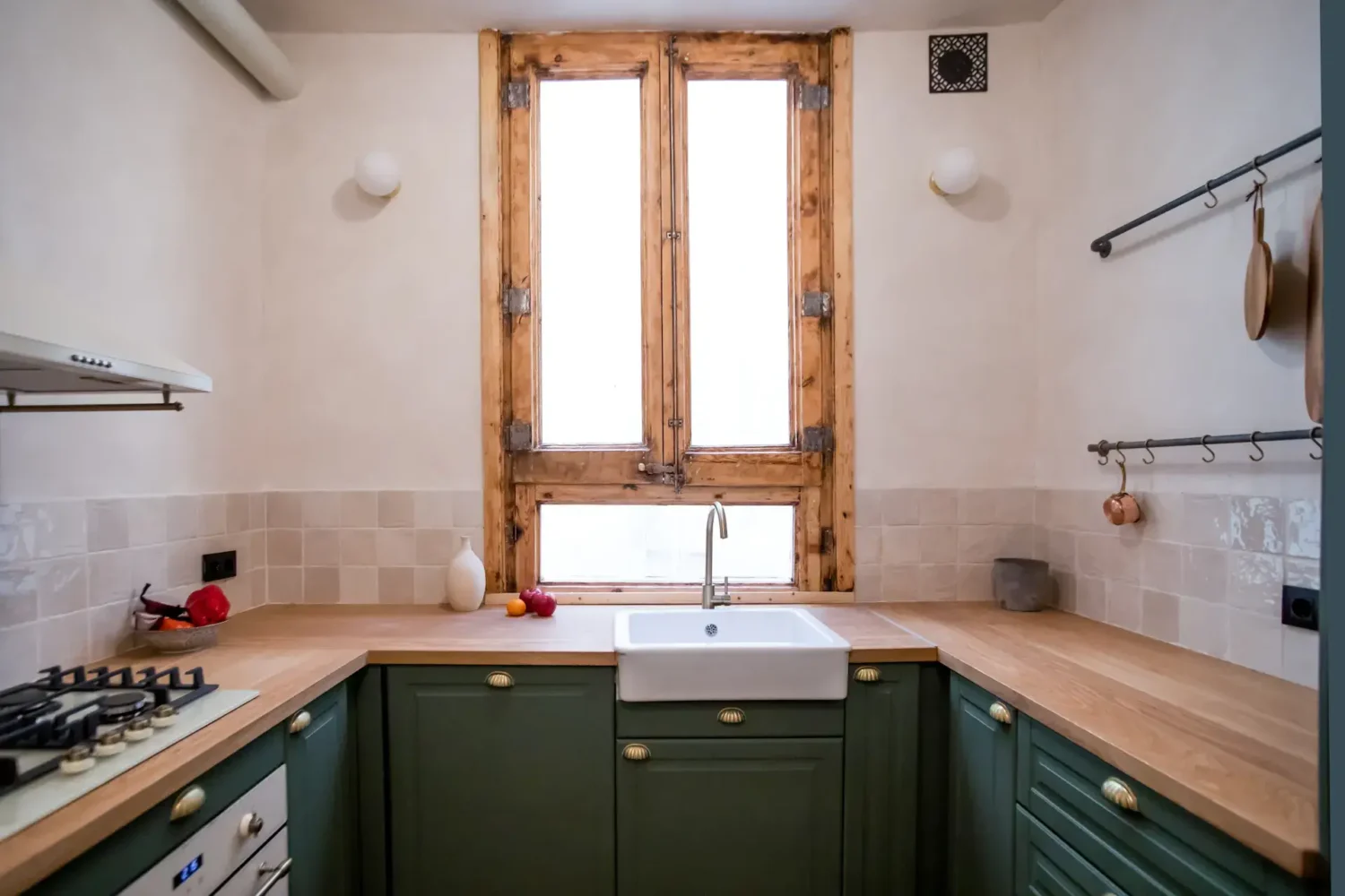 A Serene Apartment in Barcelona's Gothic Quarter 5 kitchen with green cabinets