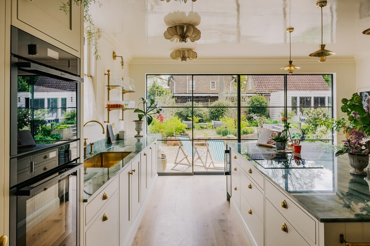 A White English House with a Beautiful Open-Plan Kitchen 2 kitchen with island and large wndows