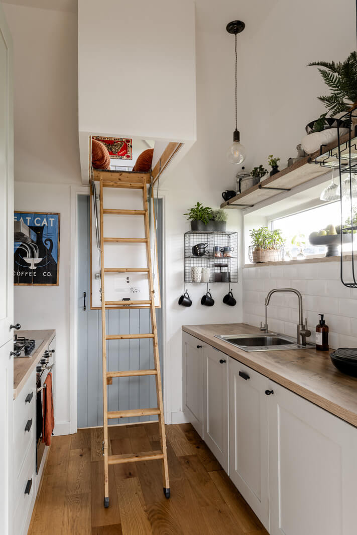 A Tiny Off-Grid House in the English Countryside 9 kitchen-with-ladder-to-loft-tiny-house-nordroom