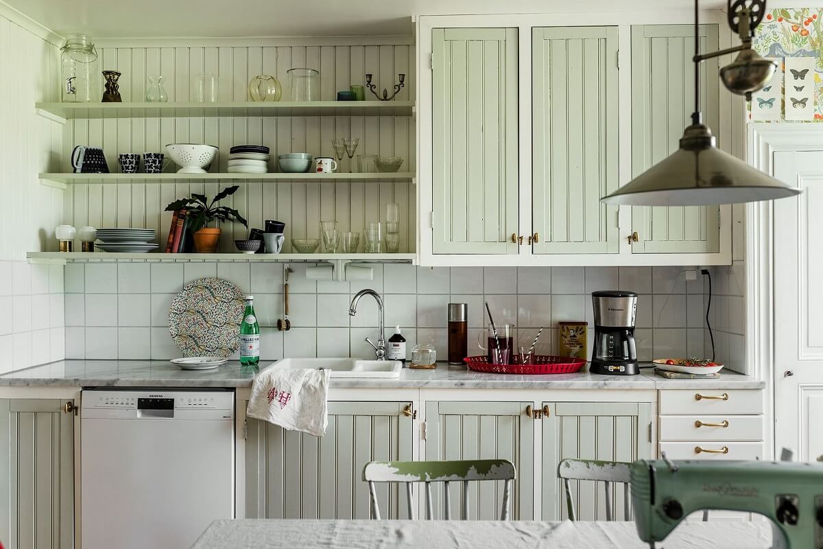 A Historic Swedish Country House with a Beautiful Garden 13 kitchen with mint green cabinets and shelves