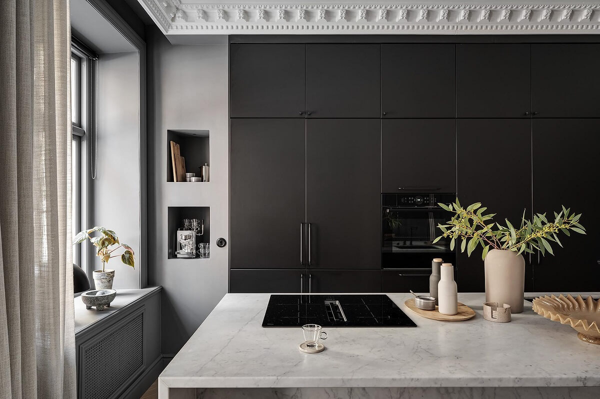 A Luxurious Renovated Apartment with Dark Gray Walls 11 kitchen with niches and wall of cabinets