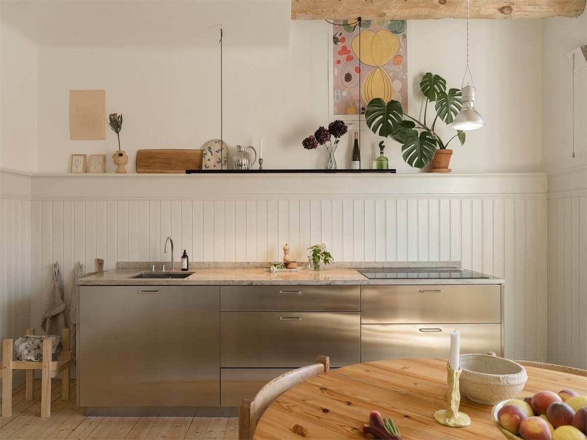 Wooden Details in a Light Duplex Apartment in Sweden 10 kitchen with stainless cabinets
