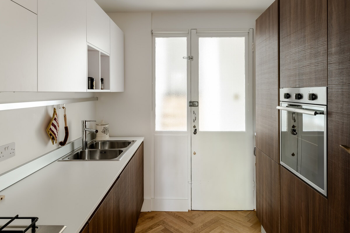 High Ceilings in a Light London Apartment 9 kitchen with walnut cabinets nordroom