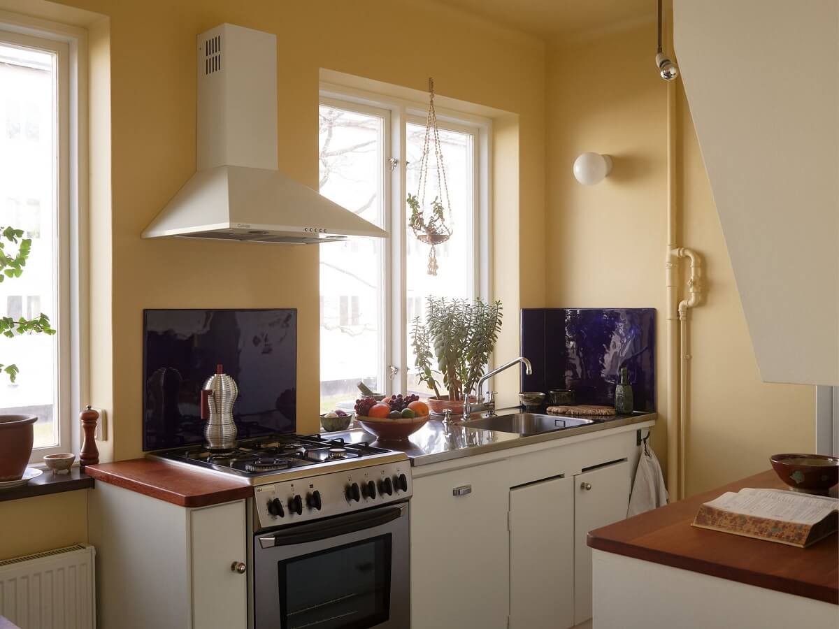 A Swedish Apartment with a Restored Original Kitchen 9 kitchen with yellow walls